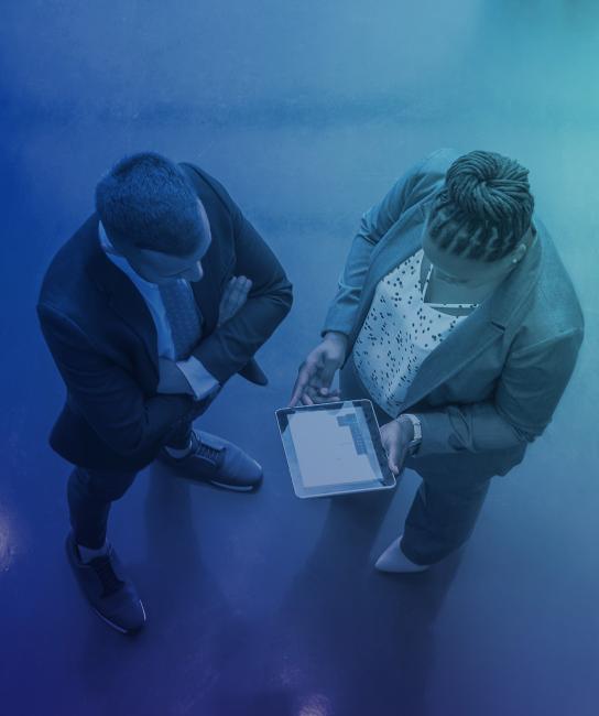 Two people looking at a tablet top down
